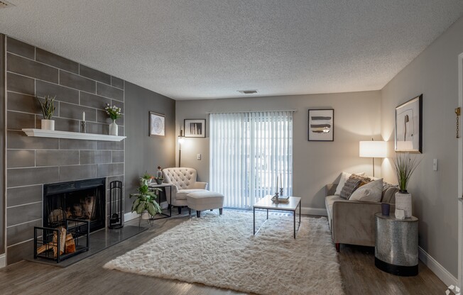 spacious living room with fireplace at the laureate apartments in laureate tx