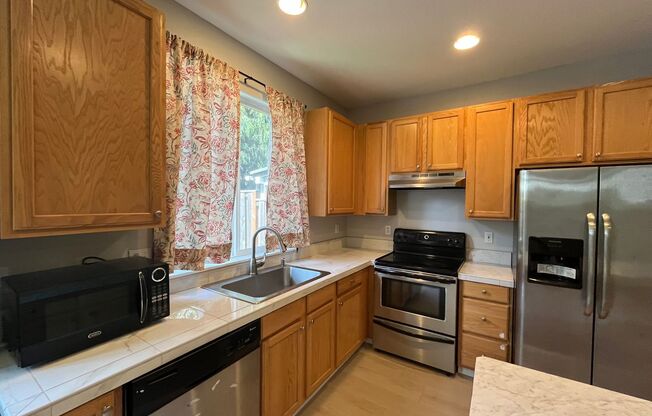 Beautiful Two-Level Townhouse with Gas Fireplace, Vaulted Primary Suite, and Fenced Backyard!