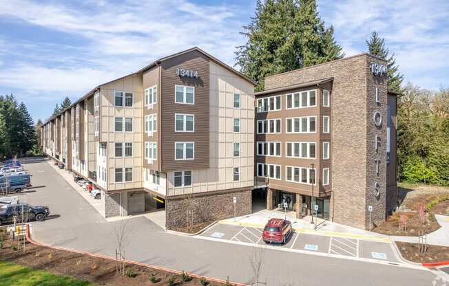 Dog-Friendly Apartments in Vancouver, WA - 134th Street Lofts - Building Exterior with a Parking Lot