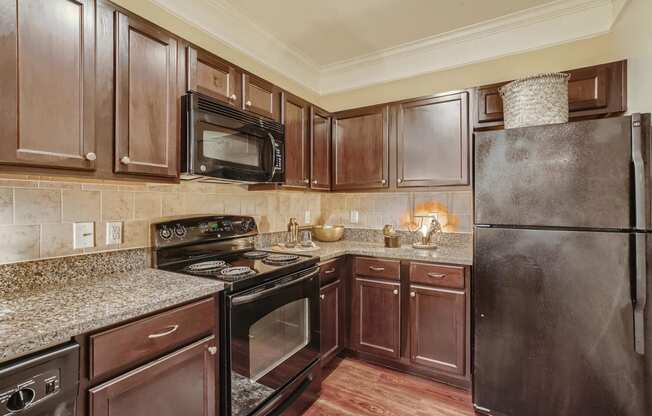 a kitchen with black appliances and granite counter tops