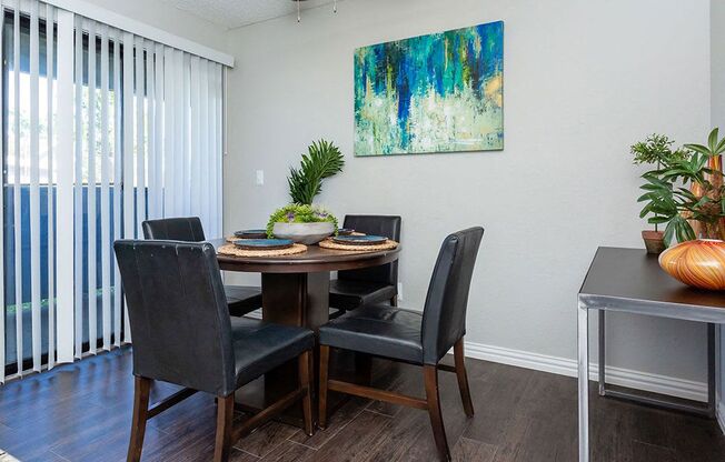 a dining room with a table and chairs