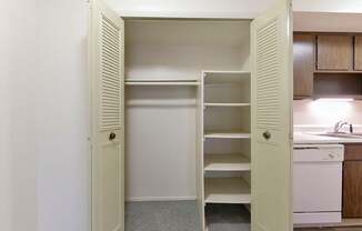 A white closet with shelves at Old Monterey Apartments, Springfield, MO