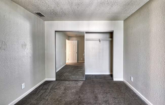 an empty room with a carpeted floor