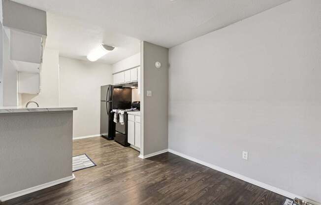 A kitchen area with a refrigerator, microwave, and oven.