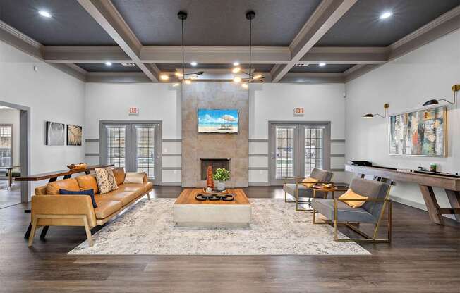 A living room with a fireplace and a TV on the wall.
