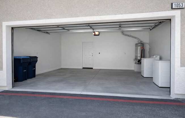 A garage with a white door and a red stripe on the floor.