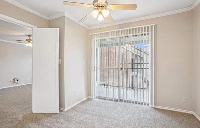Unfurnished A4 floor plan living room with a door leading to balcony and a ceiling fan Noel on The Parkway in Dallas, TX