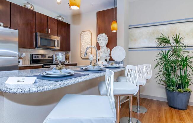 a kitchen with a table in front of a window