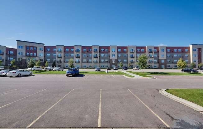 A parking lot with a building in the background.