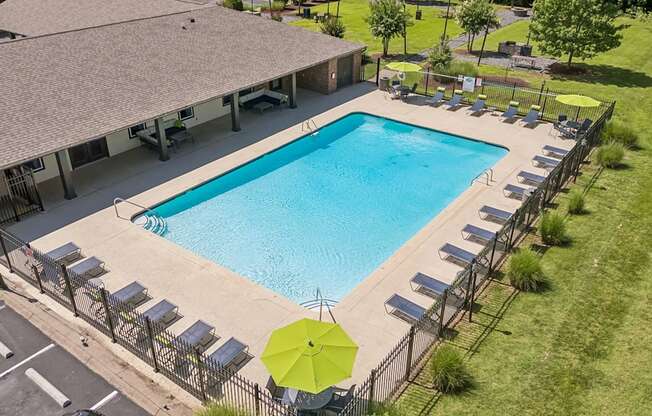 A large outdoor swimming pool surrounded by sun loungers.