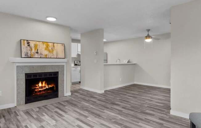 A living room with a fireplace and a painting on the wall.
