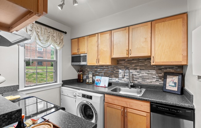 the kitchen has granite counter tops and wooden cabinets and stainless steel appliances and a window