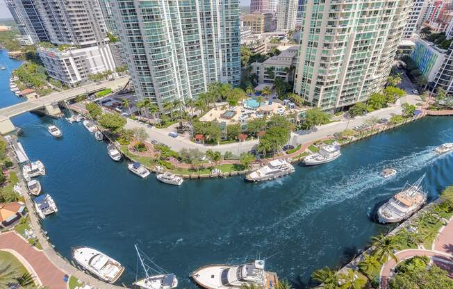 an aerial view of a harbor with boats and tall buildings