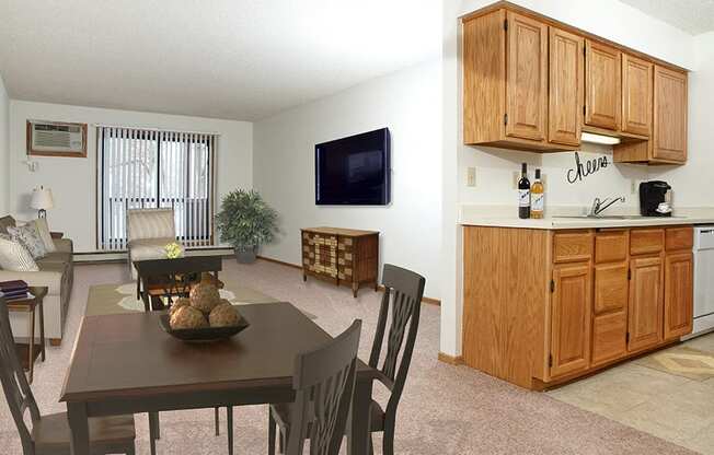 Wide shot of living room, dining table, and kitchen