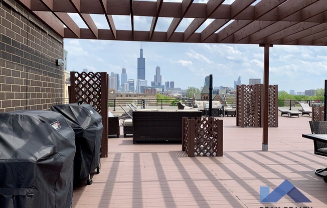 a rooftop deck with a view of the chicago skyline