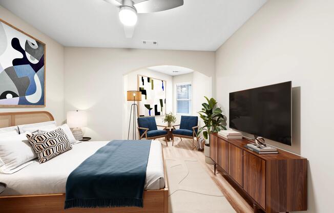 Spacious bedroom with an adjoining sitting area, arched architectural details, and a flexible layout designed for relaxing, reading, or quiet downtime.