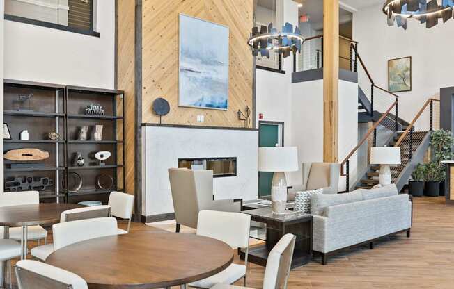 A modern living room with a wooden floor and a staircase.