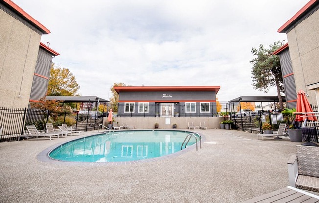 A small pool in a courtyard surrounded by buildings. at The Aviator, Washington, 98055