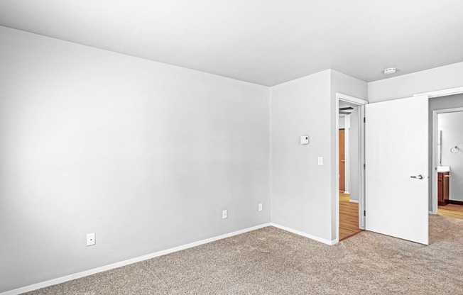 A room with white walls and a carpeted floor.