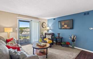 a living room with a couch and a door to a balcony