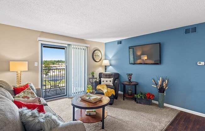 a living room with a couch and a door to a balcony