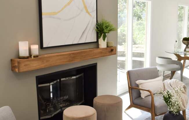 a living room with a fireplace and a painting on the wall