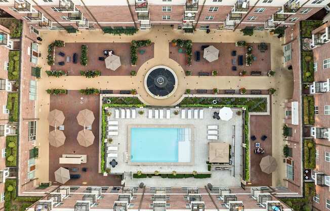 An aerial view of a courtyard with a pool and a fountain.
