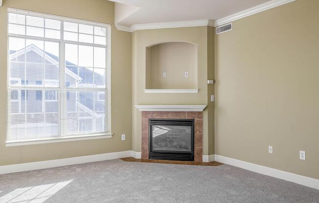 a room with a fireplace and a large window