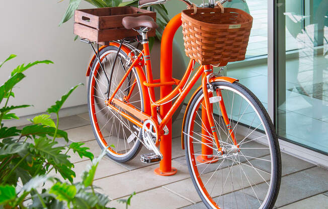 an orange bike with a basket on the front