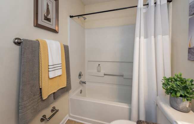 a bathroom with a shower and a sink and a bath tub