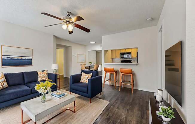 A living room with a blue couch and a coffee table.
