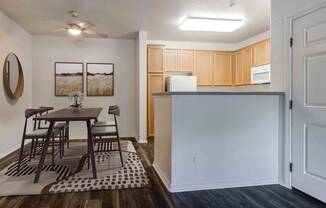 a kitchen and dining room with a table and chairs