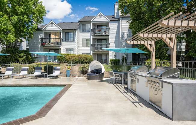 the reserve at bucklin hill pool and grilling area with lounge chairs and umbrellas