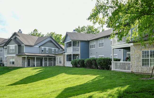 A row of houses with green lawns in front.