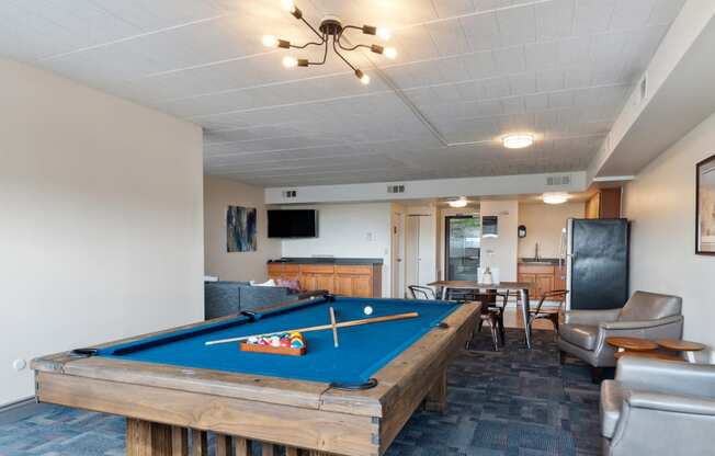 a living room with a pool table and a television