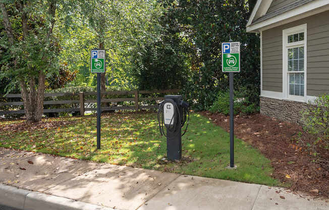 Two parking signs are on posts next to a parking meter.