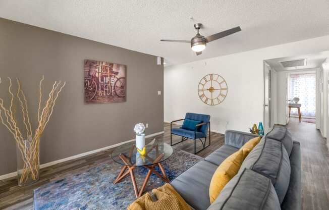 a living room with a couch and a clock on the wall