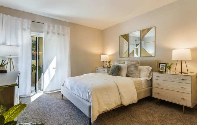 a bedroom with a bed and a door to a balcony at Mirasol Apartments, Las Vegas, 89119