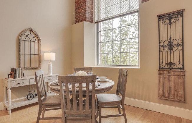 a dining room with a table and chairs