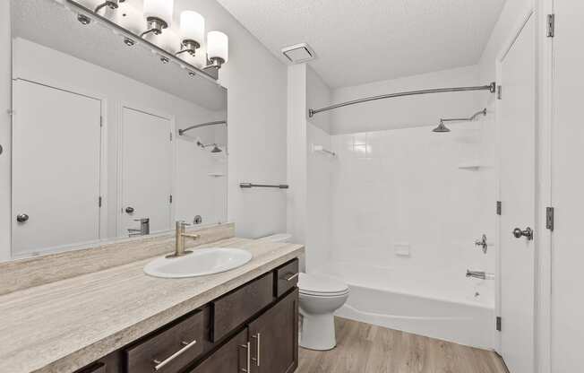 a bathroom with a toilet sink and shower