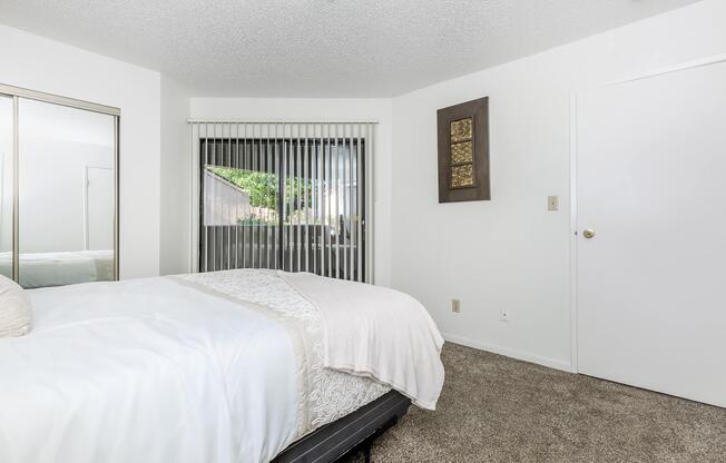 carpeted bedroom with sliding glass doors