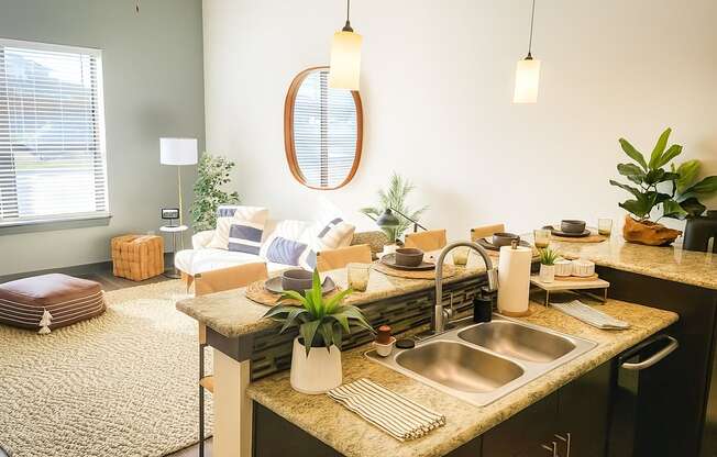 A kitchen with a sink, a mirror, and a rug.