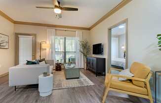 a living room with a ceiling fan and a couch at Summerwind, Pearland, TX