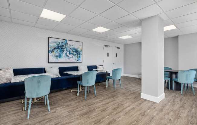 a waiting room with blue chairs and couches