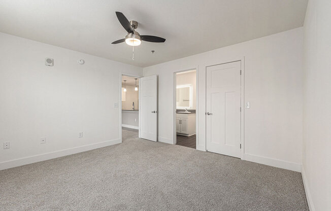 Bedroom with a ceiling fan and doors to a 2nd bathroom and closet  at Signature Pointe Apartment Homes, Athens, AL