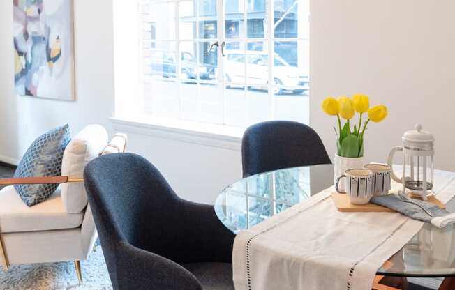 dining nook with living room and large picture window behind