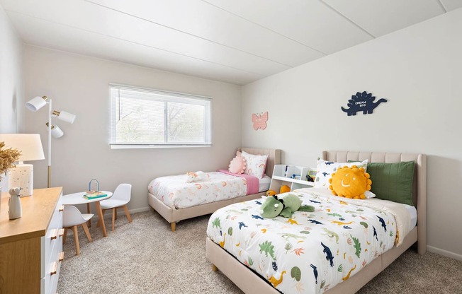 a bedroom with two twin beds and a desk