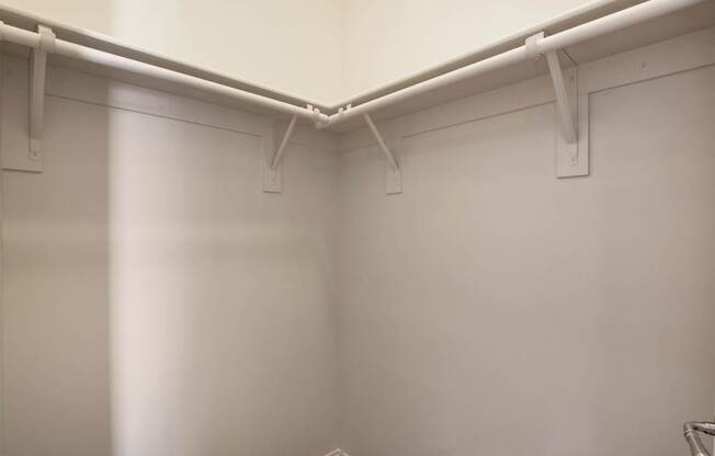 A white wall with a white pipe running along it.