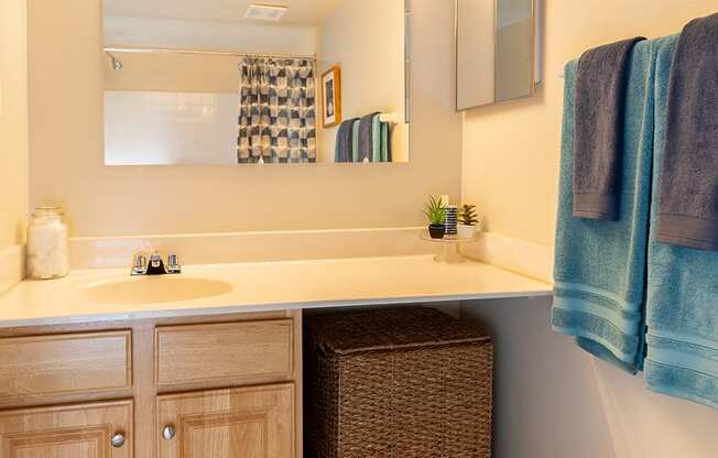 a bathroom with a mirror and towel set