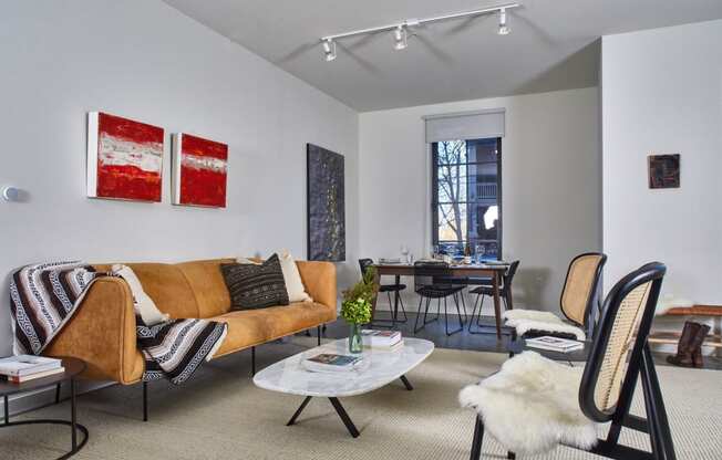 a living room with a couch and chairs and a dining room table at The Audubon New Haven, New Haven, CT, 06511
